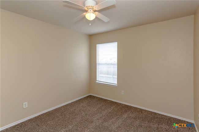 second bedroom with ceiling fan and natural light | Image 25