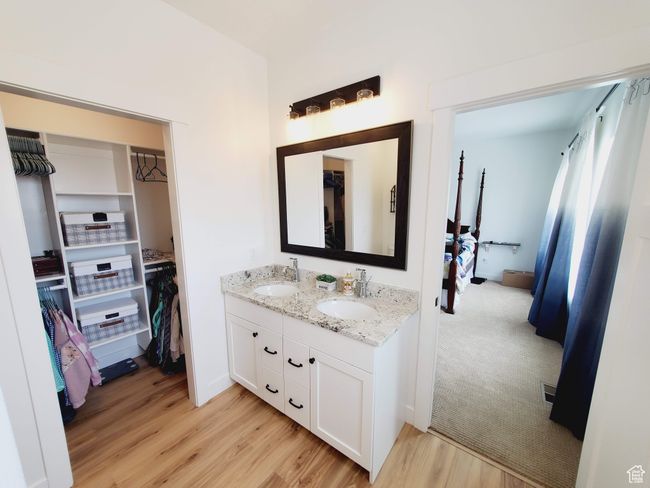 Full bathroom with double vanity, a sink, and wood finished floors | Image 20