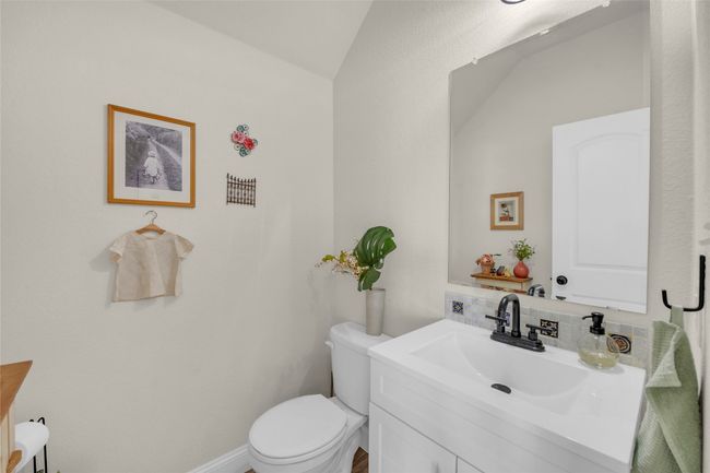 Bathroom with toilet and vanity located downstairs | Image 6