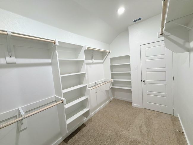 Spacious closet featuring light colored carpet and vaulted ceiling | Image 33