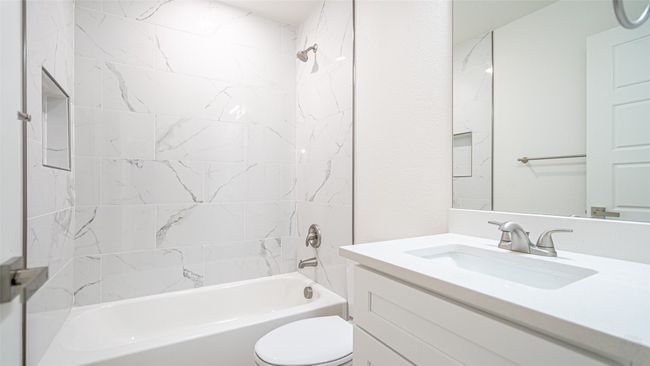 Secondary bath located off the hallway between the two secondary bedrooms. Real tub and tile surround. | Image 25