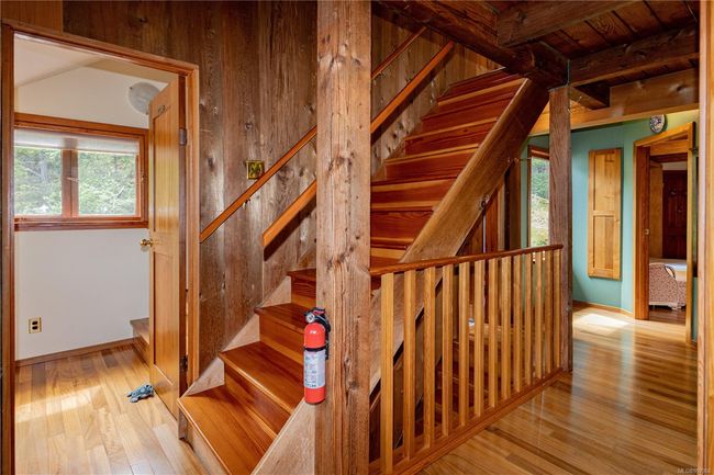 Interior hallway and staircase to the top floor where the primary bedroom is | Image 64