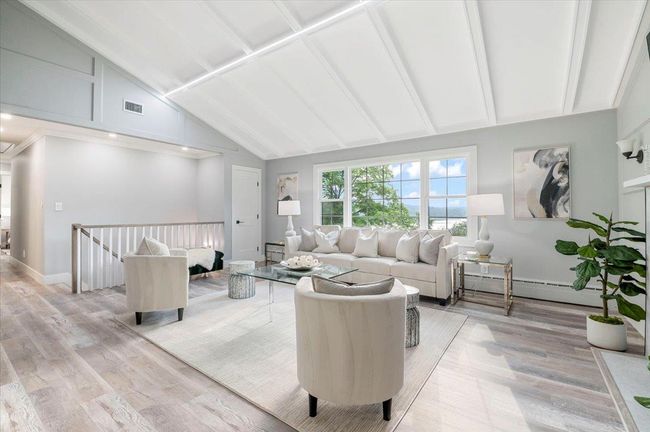 Living room featuring baseboard heating, light wood finished floors, high vaulted ceiling, and beam ceiling | Image 8
