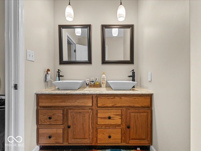 full bath featuring double vanity and baseboards | Image 14