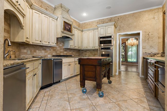 Kitchen with cream cabinetry & stainless steel appliances | Image 8
