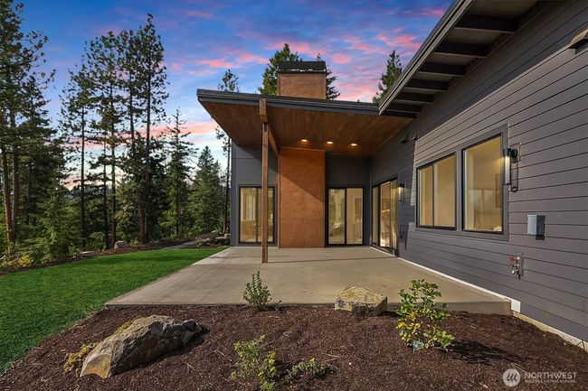 Relax and unwind on the covered rear patio, where breathtaking views of Peoh Point create the perfect backdrop for outdoor living | Image 4