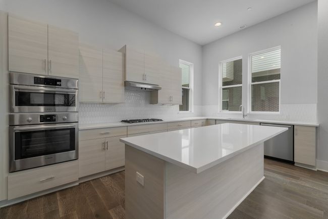 Kitchen with a sink, appliances with stainless steel finishes, light countertops, under cabinet range hood, and recessed lighting | Image 15