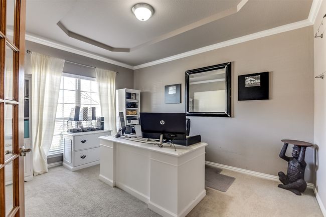 Home office featuring light carpet, a tray ceiling, and ornamental molding | Image 6