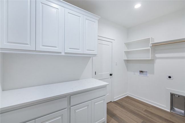 Clothes washing area featuring hookup for an electric dryer, washer hookup, cabinets, and dark hardwood / wood-style flooring | Image 21