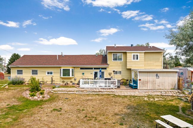 Back of house featuring a lawn and a patio | Image 89