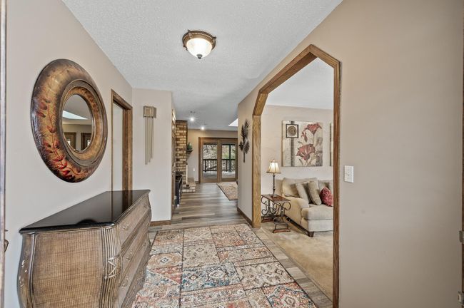 Front entry - cheery and inviting! New luxury vinyl flooring was added to flow into the family room and kitchen. | Image 7