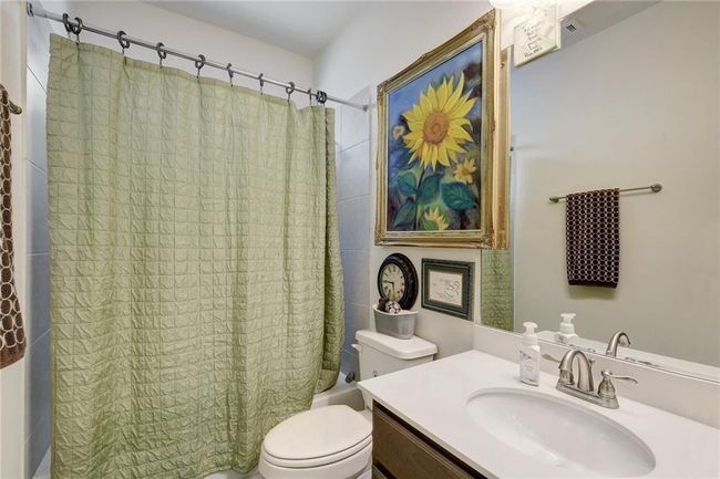 Full bathroom with shower / tub combo with curtain, toilet, and vanity | Image 24