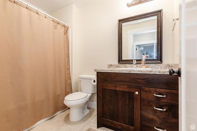 Full bath with tile patterned flooring, vanity, and a shower with shower curtain | Image 35