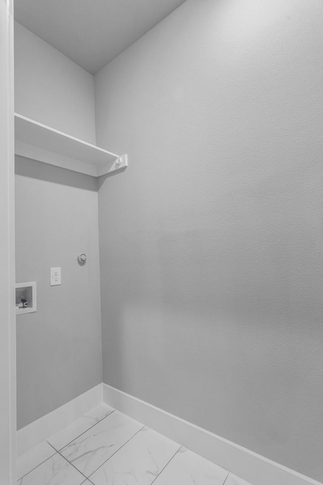Clothes washing area with baseboards, marble finish floor, laundry area, and hookup for a washing machine | Image 22
