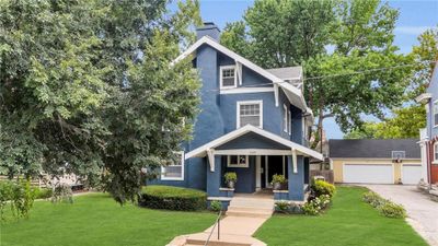 View of front facade featuring a garage, a front lawn, and covered porch | Image 2