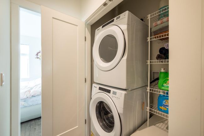 Laundry room featuring stacked washer / drying machine | Image 17