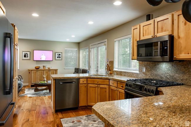 Living area featuring a fireplace, wood finished floors, and recessed lighting | Image 8