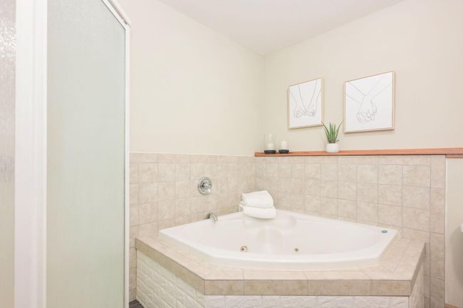 Lower level bathroom features separate soaking tub and walk-in shower. | Image 38