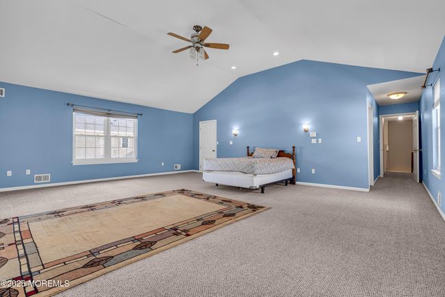 Primary massive bedroom with recessed lighting walk in closet and huge bathroom | Image 25
