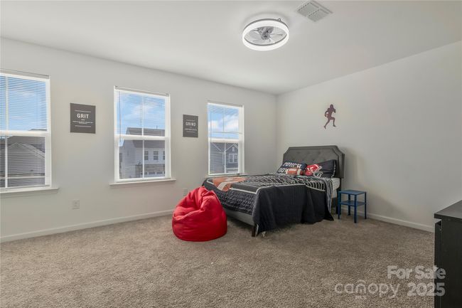 Secondary bedroom with upgraded lighting with ceiling fan and huge walk-in closet | Image 14