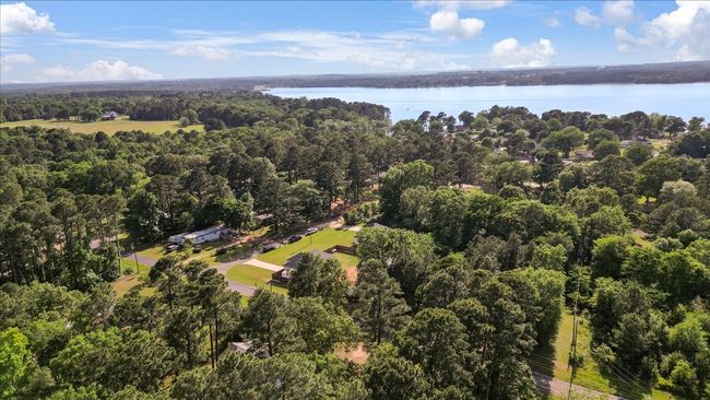 Birds eye view of property with a water view and a view of trees | Image 37