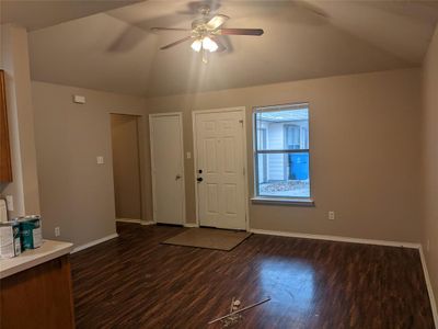 Foyer with dark wood-type flooring, ceiling fan, and vaulted ceiling | Image 3