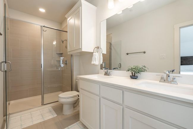 Bathroom with a shower stall and a sink | Image 16