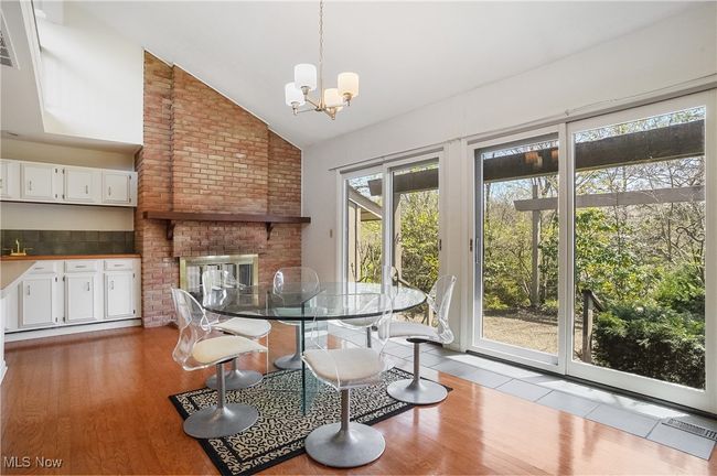 Dining room featuring high vaulted ceiling, wood finished floors, and a chandelier | Image 20