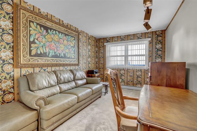 Living room with a baseboard heating unit and carpet floors | Image 18
