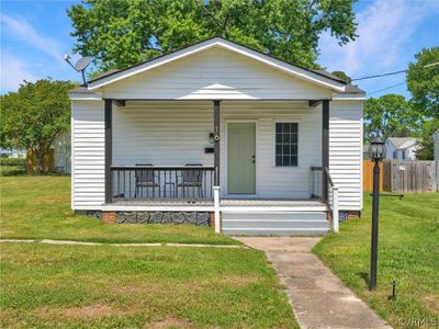 Bungalow featuring a porch and a front lawn | Image 2