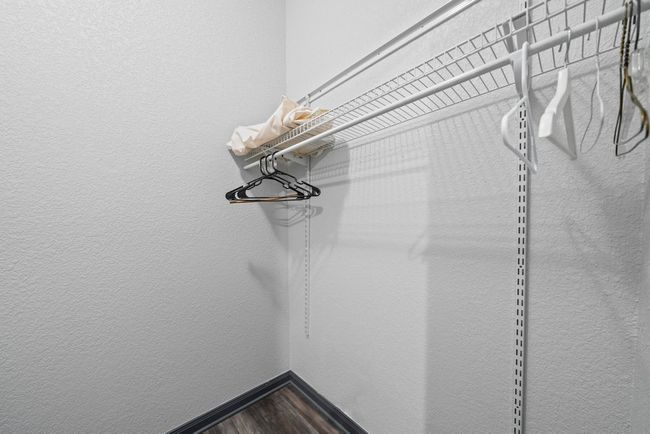 Spacious closet featuring dark wood-style floors | Image 25