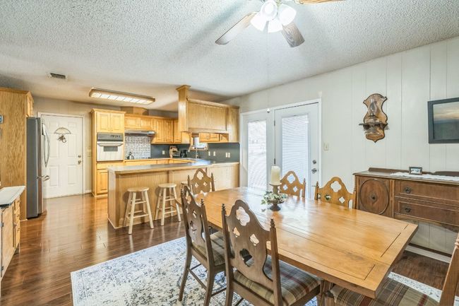 Dining space with visible vents, ceiling fan, a textured ceiling, and dark wood finished floors | Image 11