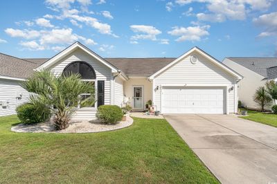 Single story home with a garage and a front lawn | Image 1