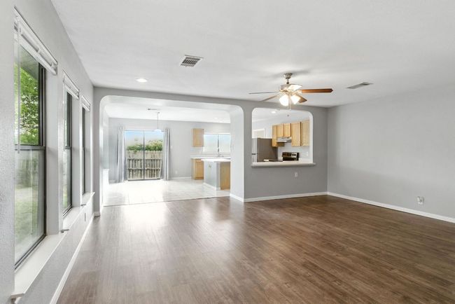 Living room taken from front door. Dining area and passthrough to kitchen are in the background. | Image 15