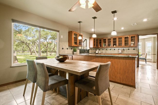 Dining room with plenty of natural light, ceiling fan, recessed lighting, and light tile patterned floors | Image 5