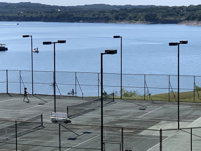View of tennis court with a water view | Image 38