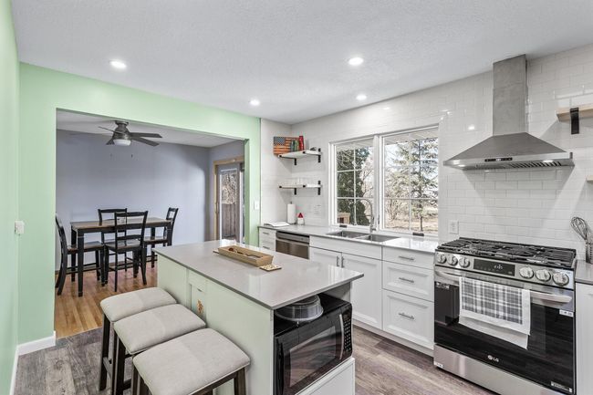 Additional view of the kitchen showing lots of natural light with the large window over the sink and walks into the informal dining area. | Image 6
