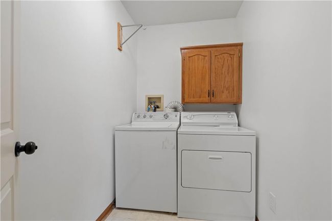 Laundry room featuring cabinet space and washer and clothes dryer | Image 8