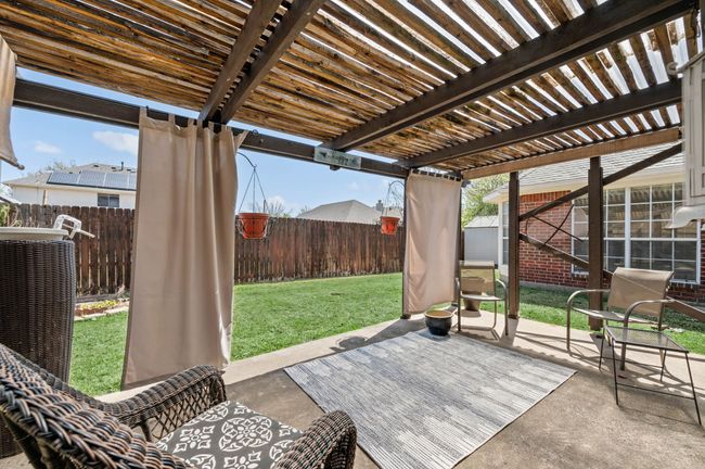 View of patio / terrace with central air condition unit, a fenced backyard, and a pergola | Image 33