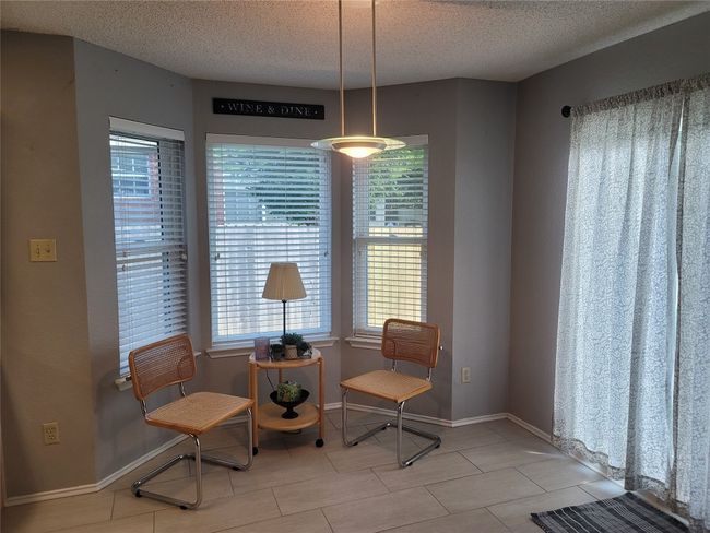 Dining room featuring a bay window | Image 6