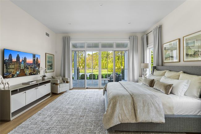 Bedroom with access to exterior and wood finished floors | Image 23