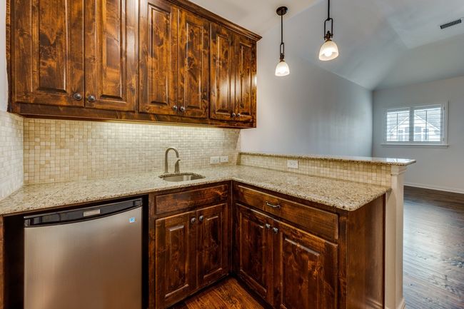 Wet Bar with frig, a sink, dark wood-type flooring, and a peninsula | Image 18