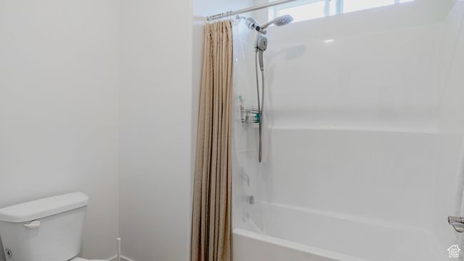 Full bathroom featuring shower / bath combo and toilet | Image 22