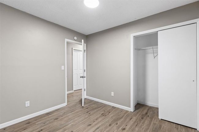 Unfurnished bedroom featuring a closet, baseboards, and light wood-style floors | Image 16