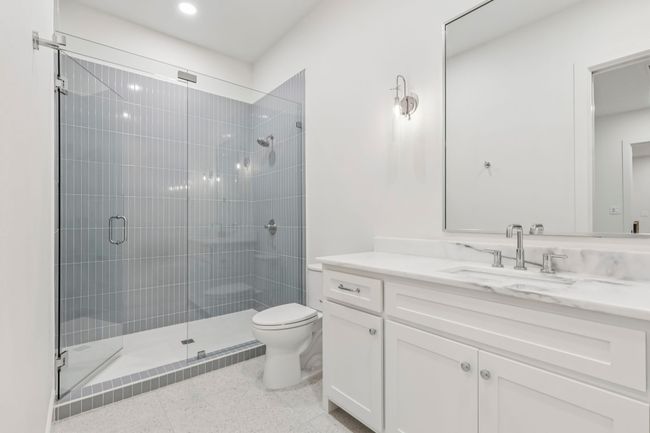 Full bathroom featuring vanity, a shower stall, dark aggregate flooring, and recessed lighting | Image 20