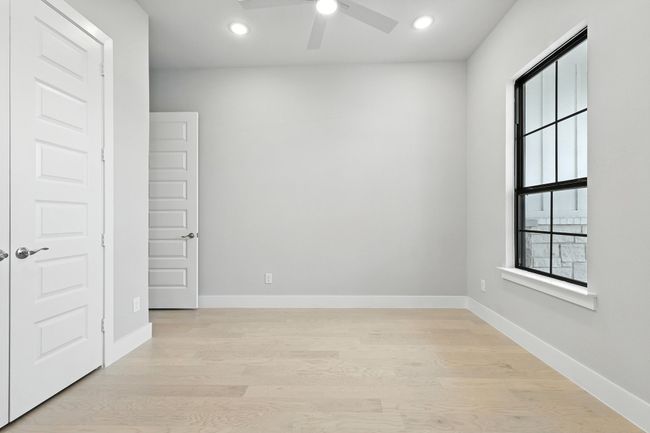 4th bedroom featuring light wood finished floors, a ceiling fan, and recessed lighting | Image 21