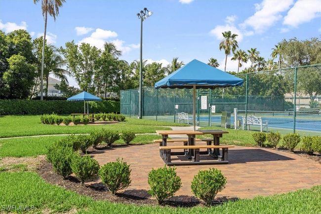 View of property's community featuring tennis court and a yard | Image 46