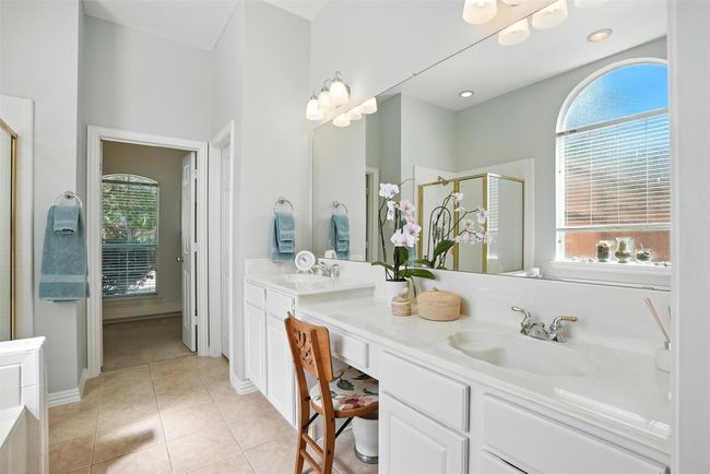 Bathroom featuring a stall shower, double vanity, and tile patterned floors | Image 18