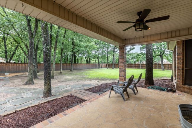 Fenced backyard featuring a patio area and a ceiling fan | Image 11