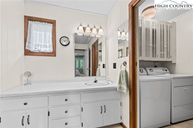 The laundry is conveniently located in the primary bathroom. | Image 10